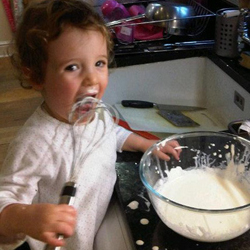 Lizey helping with the cooking... eating the cream off the whisk